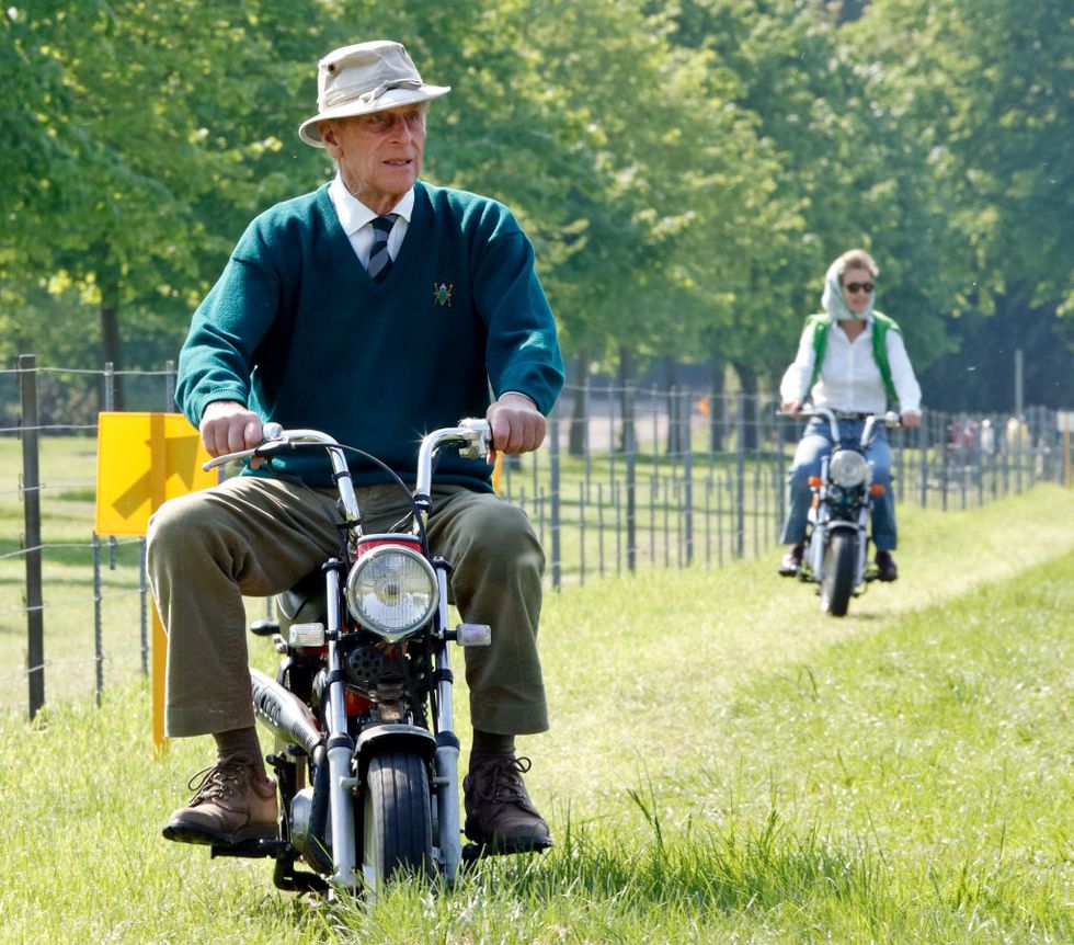 windsor, united kingdom   may 11 embargoed for publication in uk newspapers until 24 hours after create date and time prince philip, duke of edinburgh and penelope knatchbull, lady brabourne seen riding mini easy rider motorbikes as they attend day 1 of the royal windsor horse show in home park on may 11, 2006 in windsor, england photo by max mumbyindigogetty images