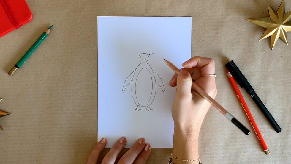 hand holding a pencil over a drawing of a penguin on white paper