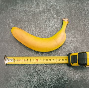 a banana next to a measuring tape