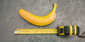 a banana next to a measuring tape