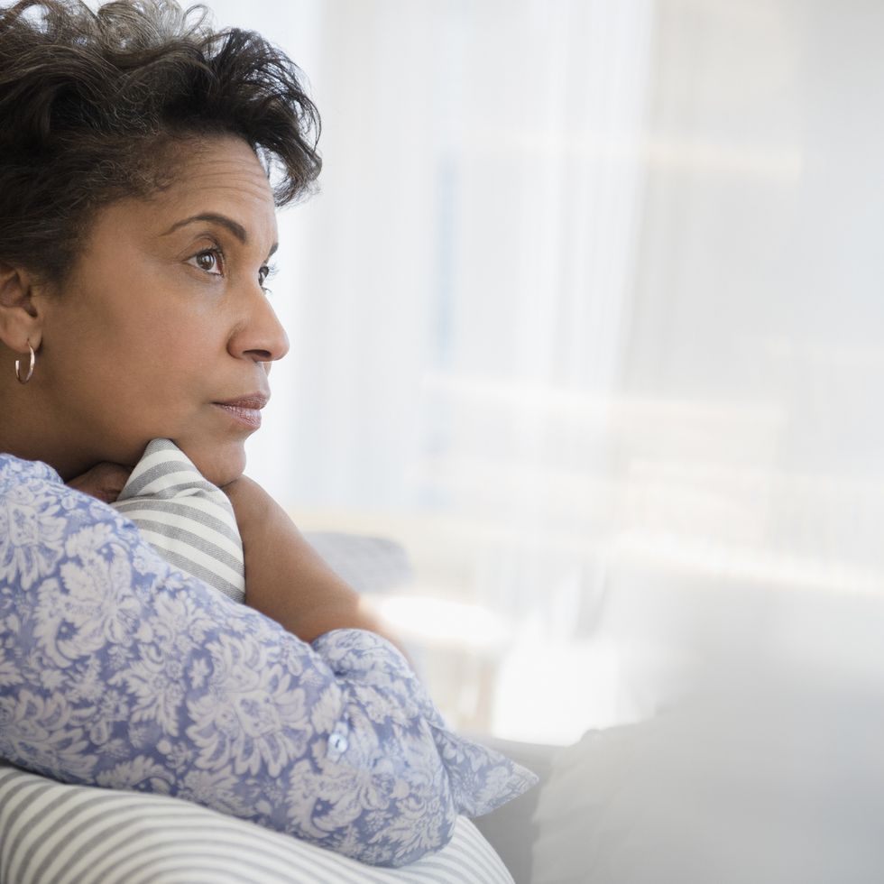 how to forgive yourself pensive older black woman clutching pillow