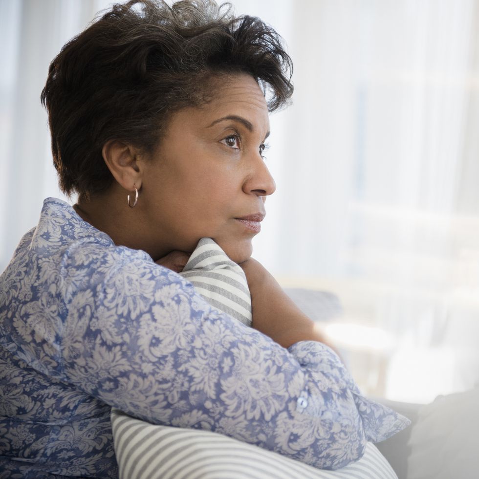 how to forgive yourself pensive older black woman clutching pillow