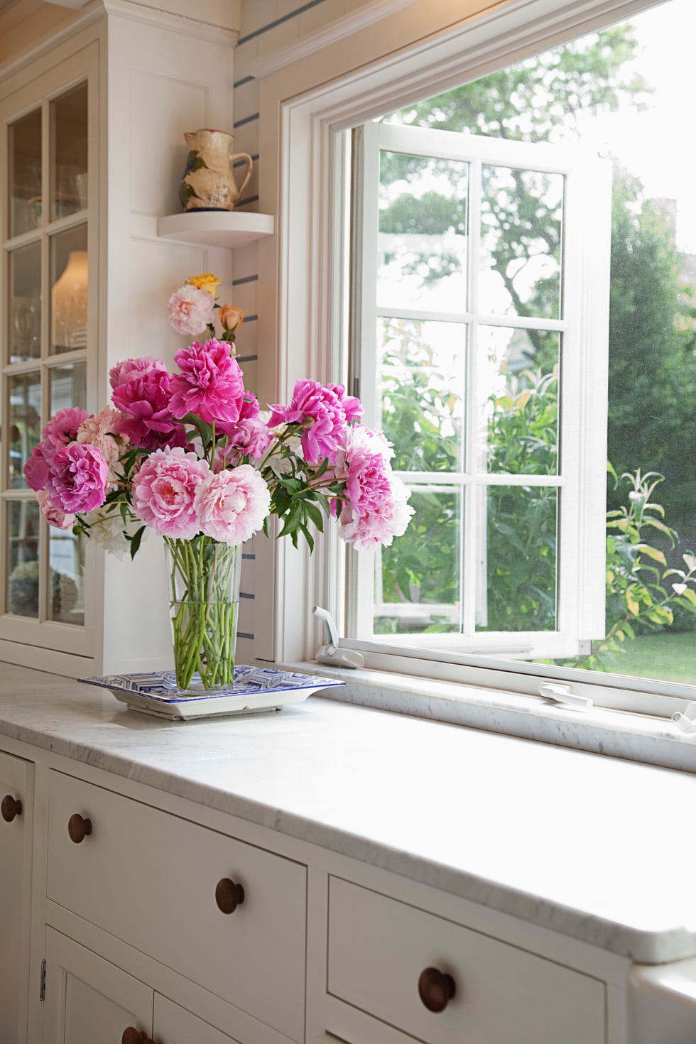 Peony bouquet next to window