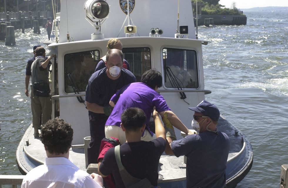 People are evacuated by boat after the attack on the World Trade Center on September 11, 2001