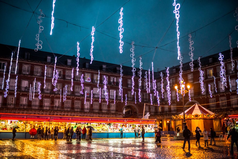 people buying gifts at christmas market, madrid