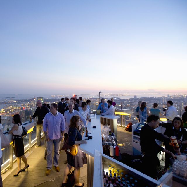 people enjoying sunset from rooftop bar