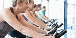 People exercising on stationary bikes in fitness class