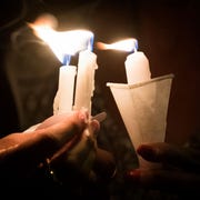 people-hold-candles-as-they-pray-during-a-candlelight-vigil-news-photo-1676567547.jpg?crop=0.726xw:1.00xh;0.131xw,0&resize=180:*