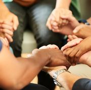 people holding hands together during a support group meeting