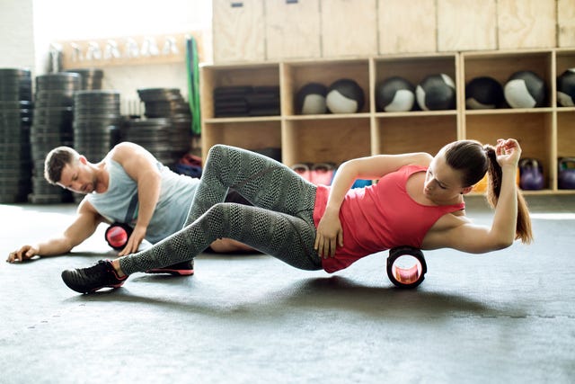 People in gym using support roller