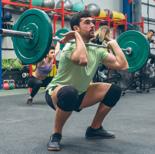 people practicing weightlifting in the gym