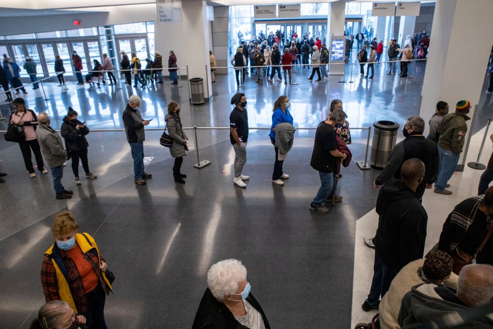 people wait to receive a coronavirus disease covid 19