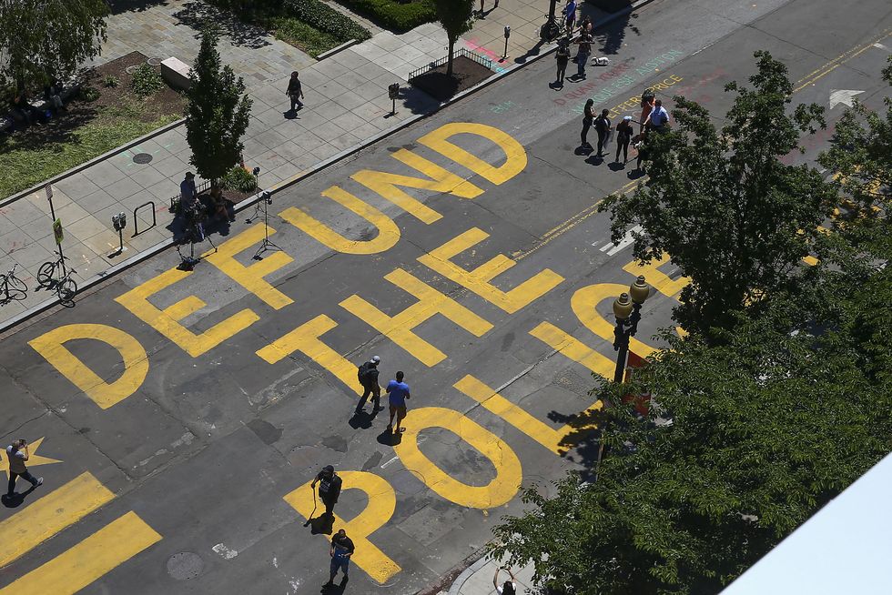 protestors add "defund the police" messaging to washington dc street