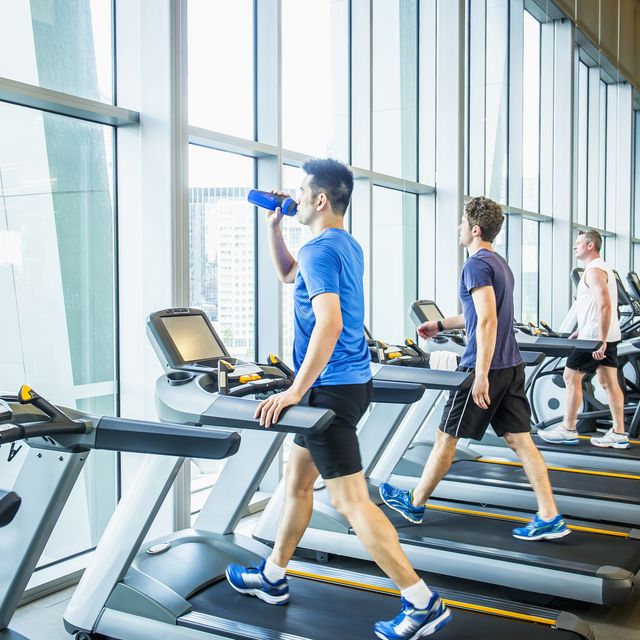 people working out on treadmills in gymnasium