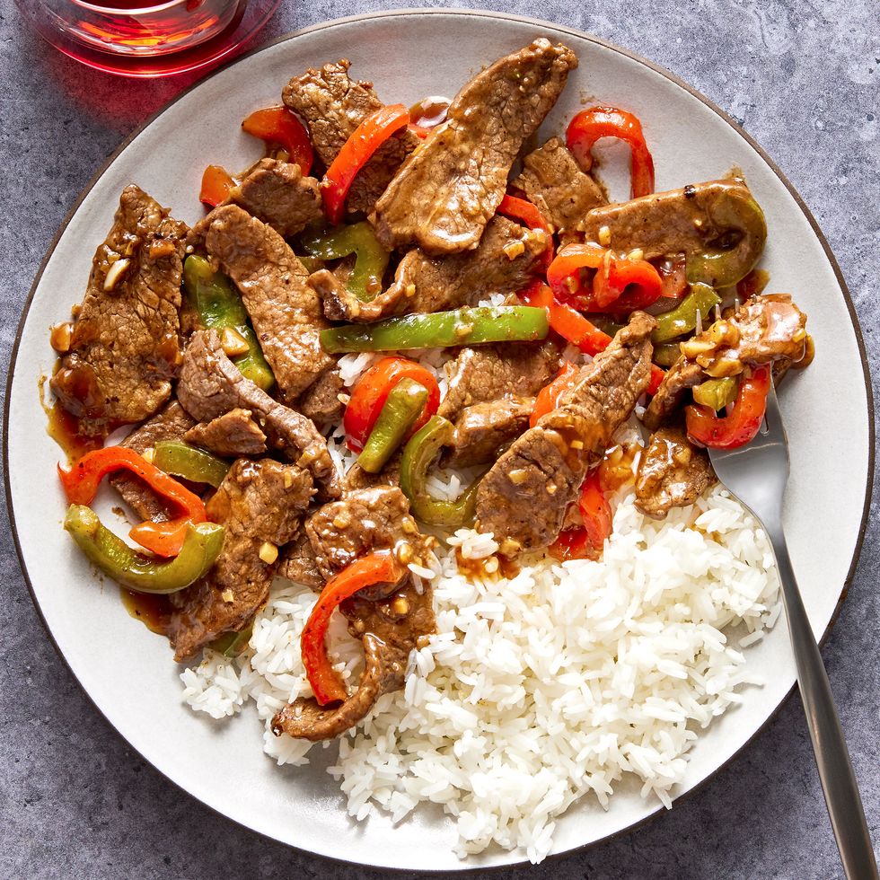 steak with sliced red and green peppers