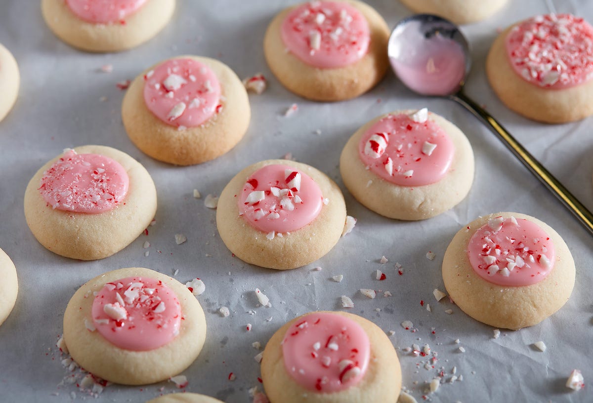 peppermint meltaways cookies topped with pink icing and crushed peppermint cookies