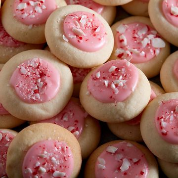 peppermint meltaways cookies topped with pink icing and crushed peppermint cookies