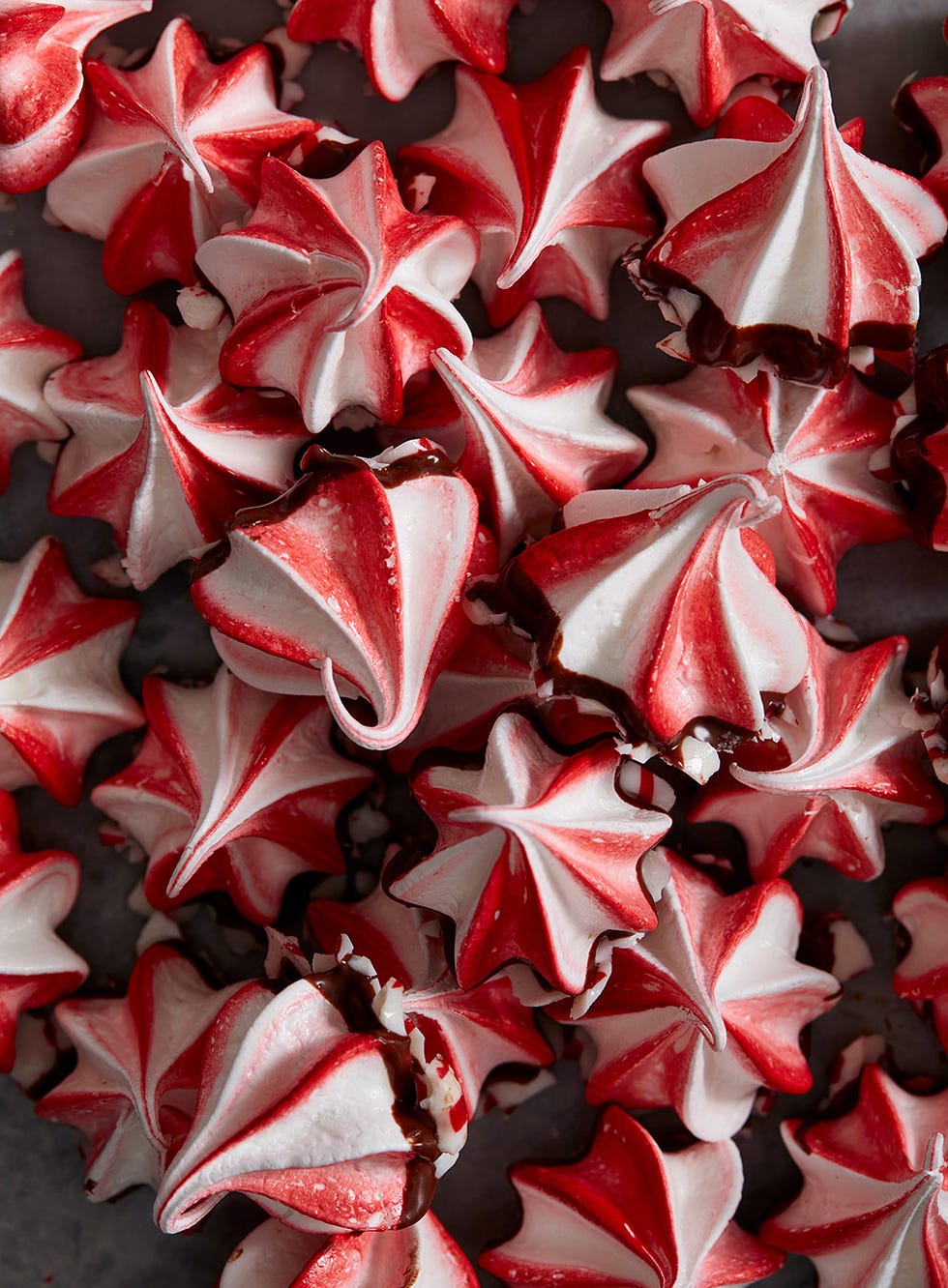 red and white swirled peppermint meringues dipped in chocolate and crushed peppermint