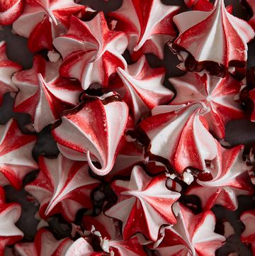 red and white swirled peppermint meringues dipped in chocolate and crushed peppermint