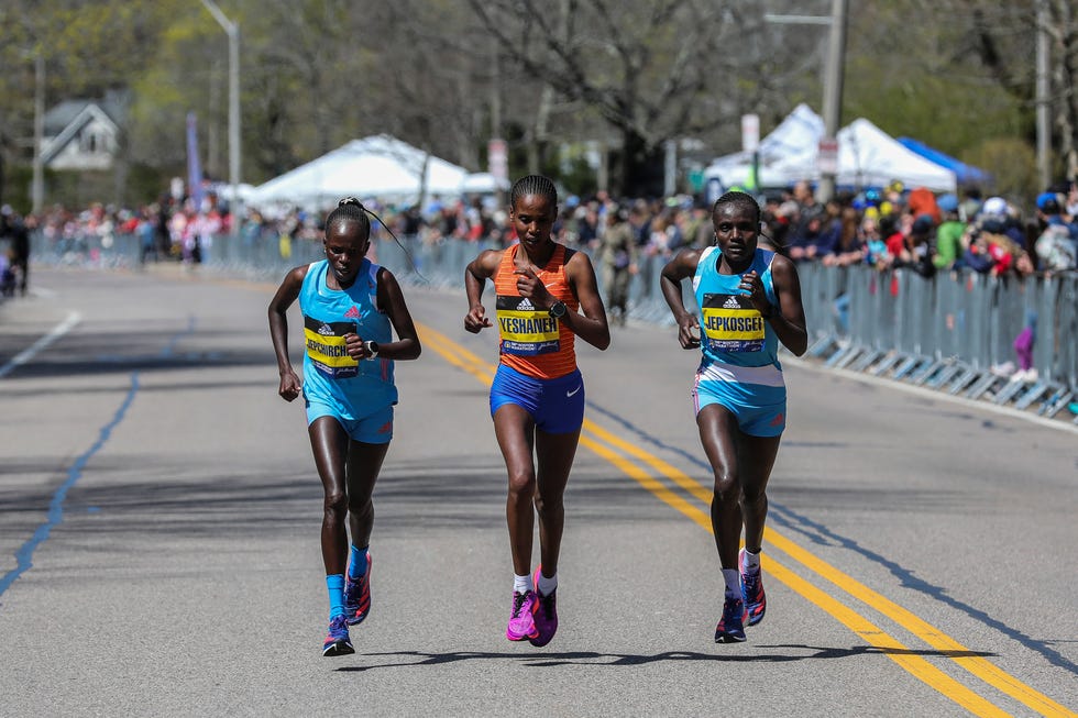 newton, ma   april 18 peres jepchirchir, left,  ababel yeshaneh, and joyciline jepkosgei crest heartbreak hill during the in newton, ma on april 18, 2022 photo by erin clarkthe boston globe via getty images