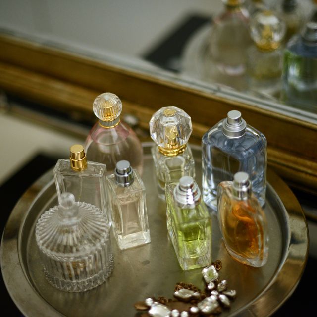 perfume bottles on a tray by a mirror
