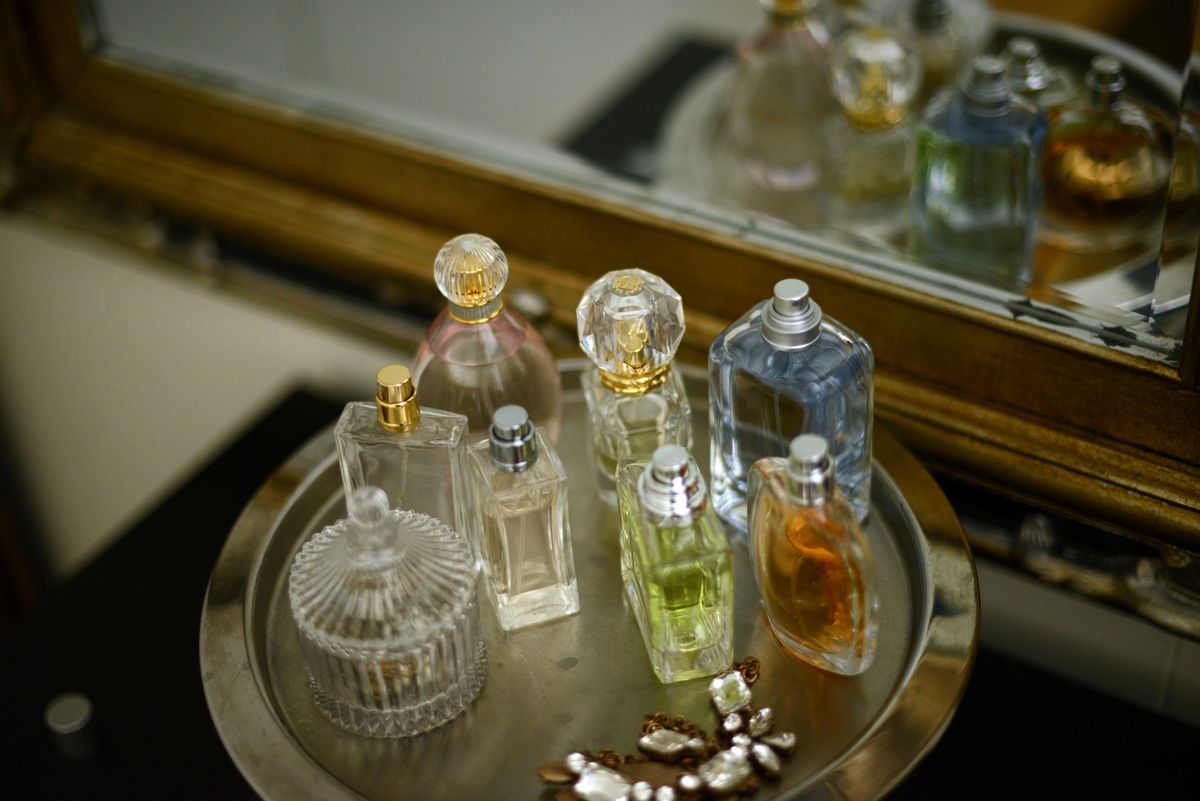 perfume bottles on a tray by a mirror