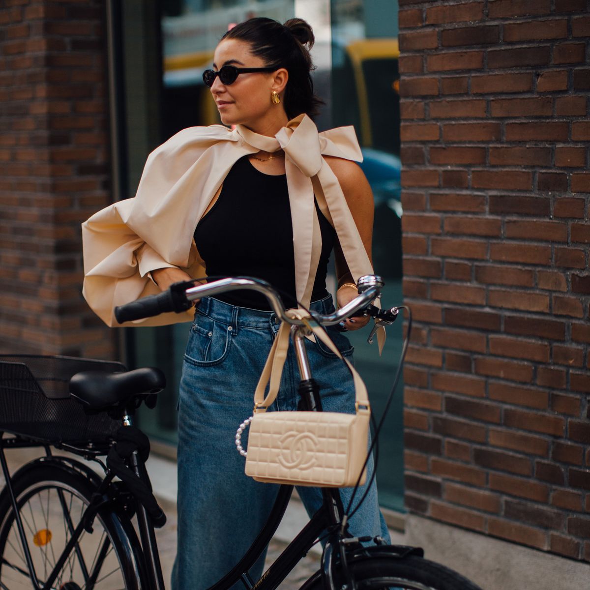 a woman with a bag and a bicycle
