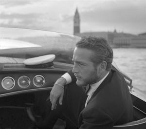 american actor paul newman, wearing a tuxedo and a bow tie, portrayed during a trip on a water taxi, a sailor cap on the dashboard, st mark square in the background, venice 1963 photo by archivio cameraphoto epochegetty images