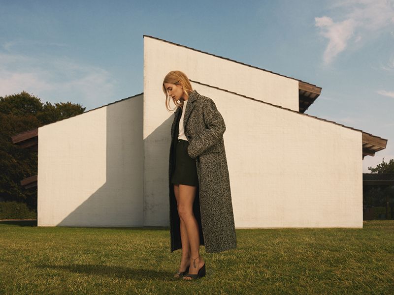 pernille teisbaek models clothing from her collaboration with mango in front of a house
