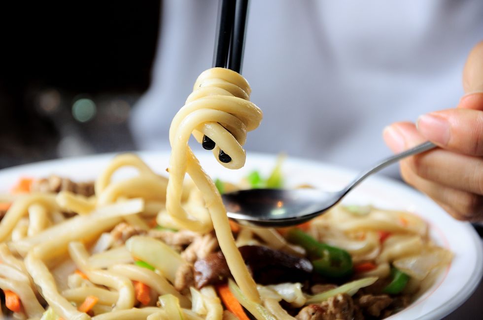 person eating noodles