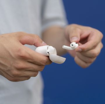 person holding a wireless earbuds case