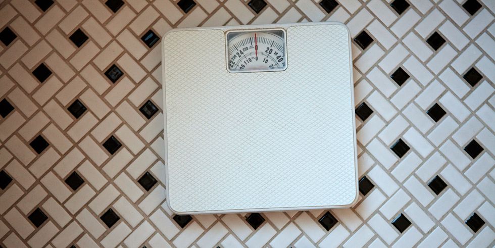 person standing in front of bathroom scales