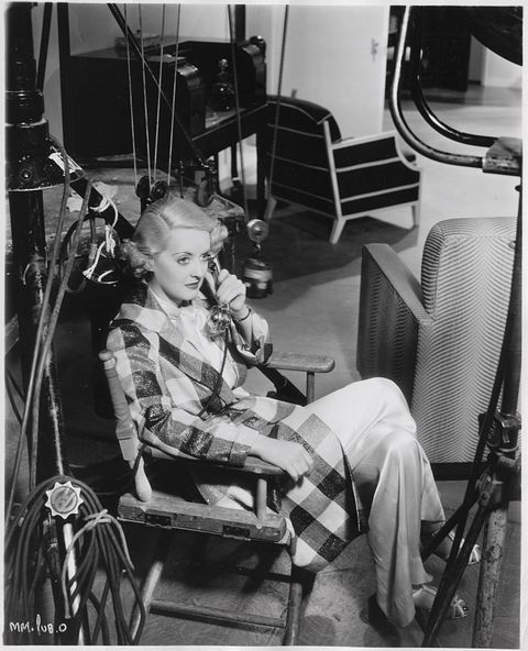 Actress Bette Davis Sitting on Set and Talking on Telephone