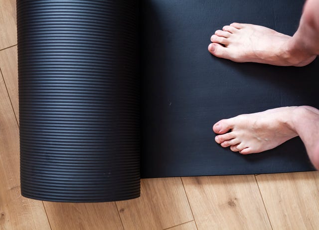 personal perspective of man standing on exercise mat