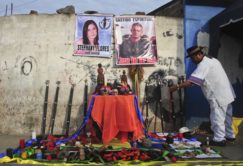 a shaman ceremony takes place in front of posters of joran van der sloot and stephany flores