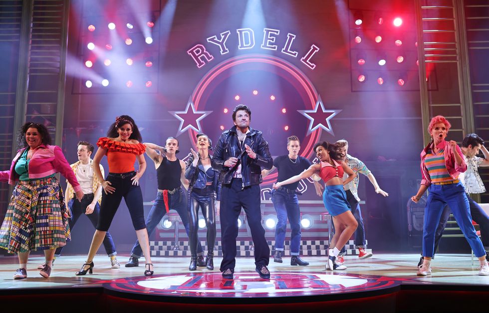 mary moore, noah harrison, jocasta almgill, paul french, olivia moore, peter andre, dan partridge, lizzy rose esin kelly, jake reynolds, eloise davies and damon gould bow at the curtain call during the press night performance of grease the musical