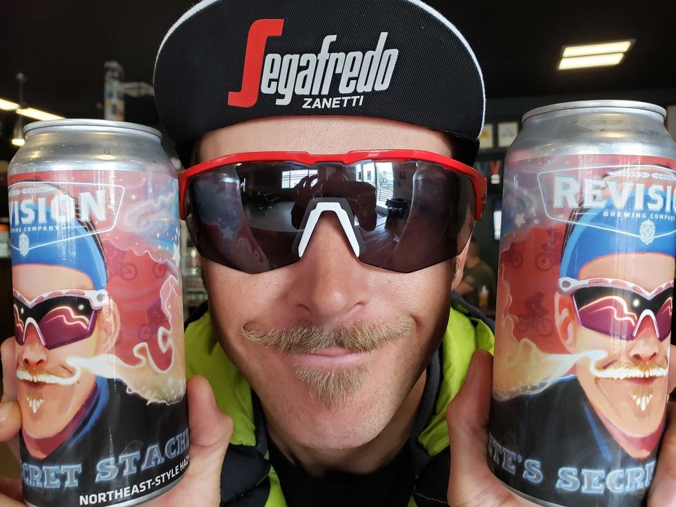 peter stetina holding revision pete's secret stache beer with his image on it