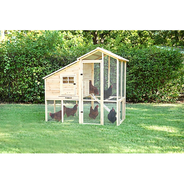 a light brown wooden chicken coop in a grassy yard