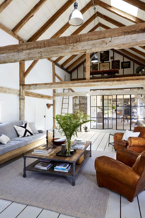 an open room with white walls and wooden beams