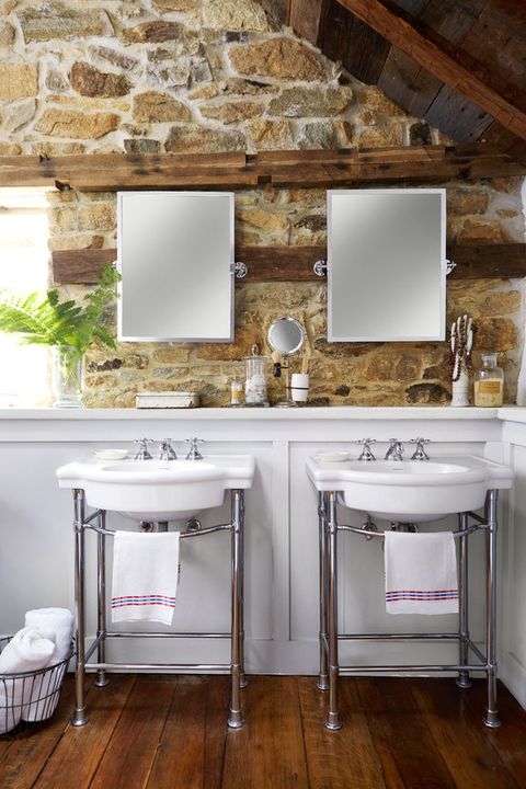 double sinks in a bathroom with a mirror hanging above each