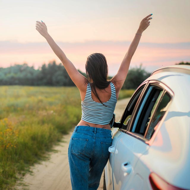 a man standing next to a car