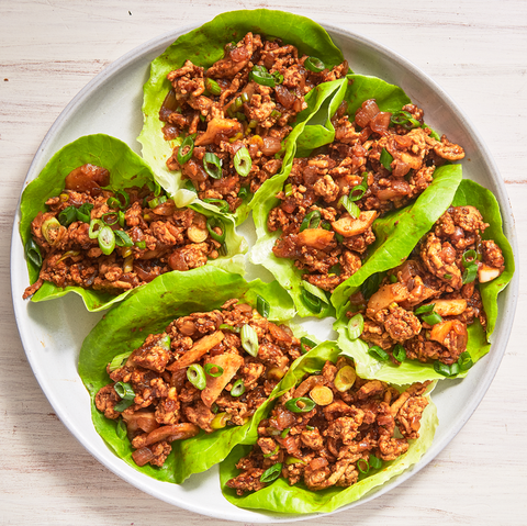 6 asian chicken lettuce wraps on a white plate