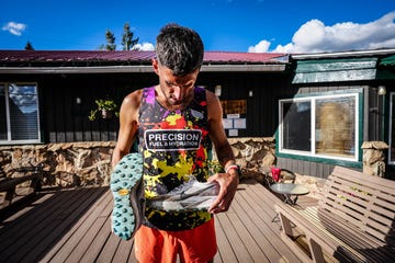 runner displaying two pairs of shoes outdoors