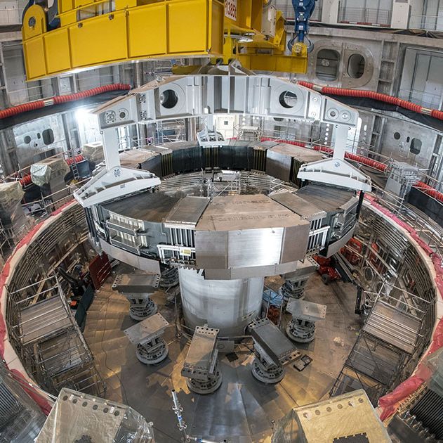 this photo shows the installation of the first superconducting magnet, poloidal field coil number 6, in the tokamak pit at the iter construction site