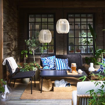cozy outdoor seating area with plants and decorative elements cozy outdoor seating area with plants and decorative elements