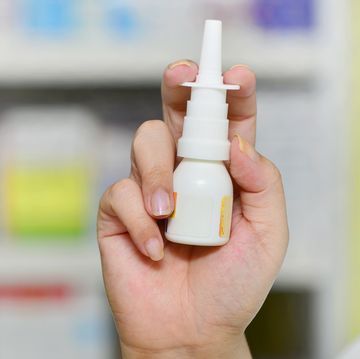 pharmacist holding nasal spray medicine