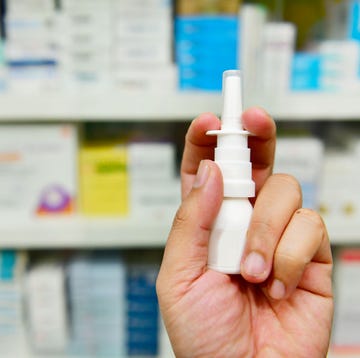 pharmacist holding nasal spray medicine