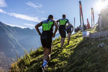 a group of people running on a mountain