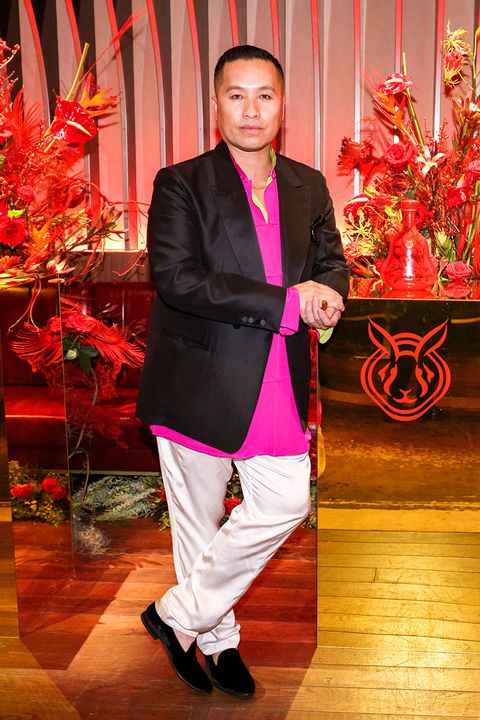 phillip lim wears a pink shirt, black jacket, and white pants at a lunar new year party in 2023