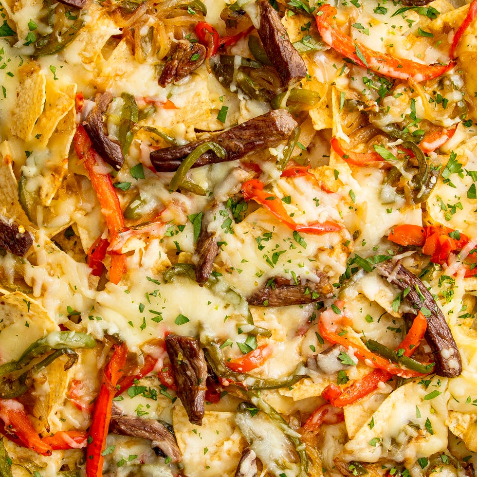 nachos topped with philly cheesesteak inspired ingredients